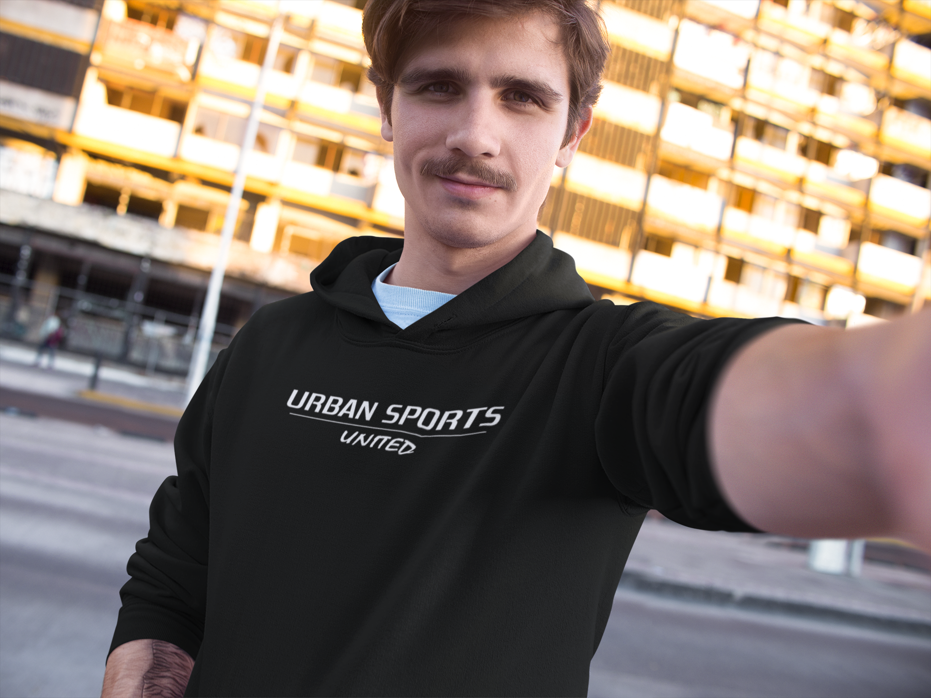 selfie-mockup-of-a-young-white-man-wearing-a-pullover-hoodie-in-the-city-a13611